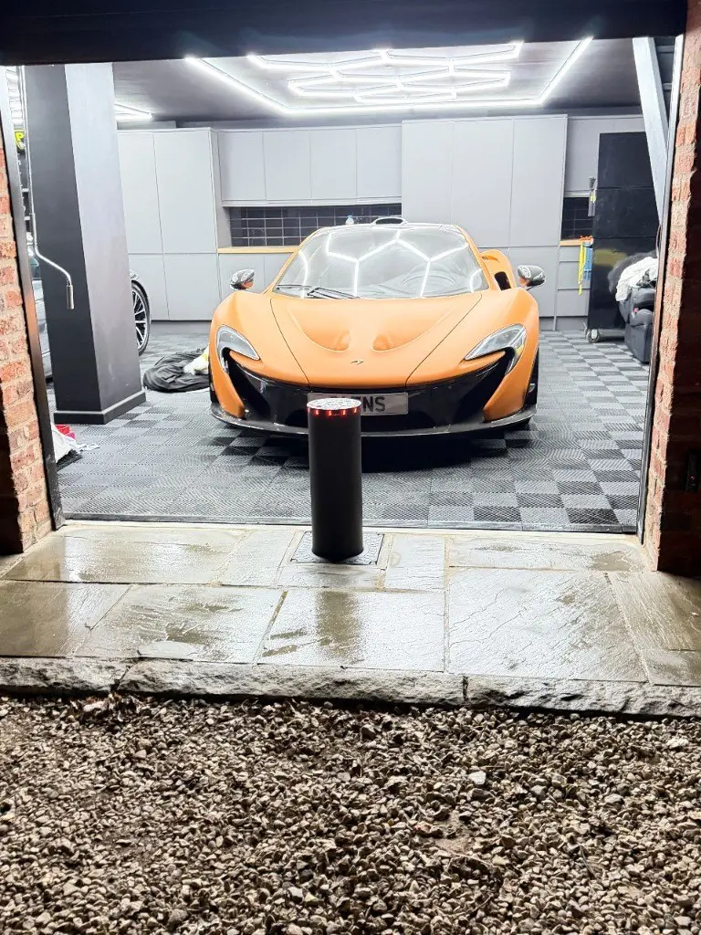 McLaren P1 protected by a rising bollard