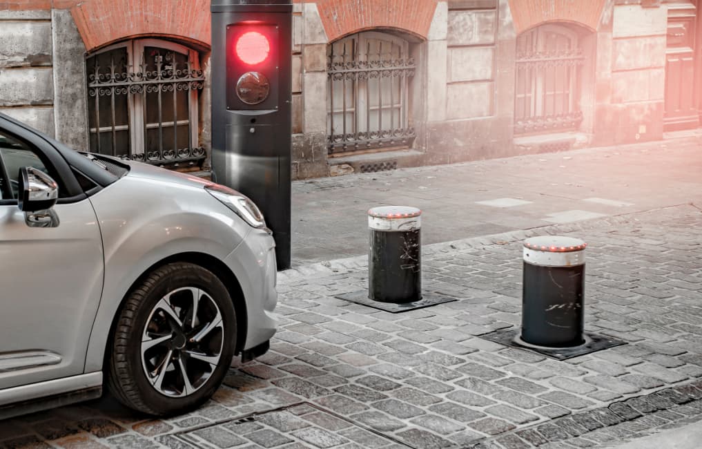 Cars next to traffic controlled bollards
