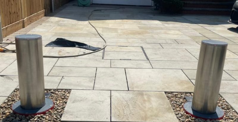 Two metal Eco Rise Bollards on a driveway