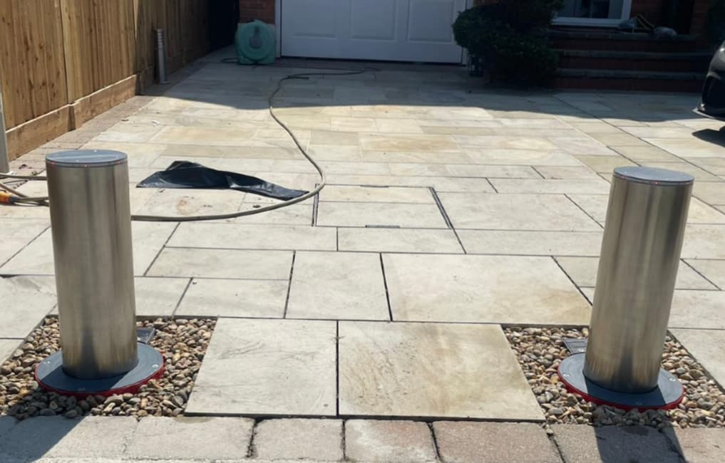 Two metal Eco Rise Bollards on a driveway