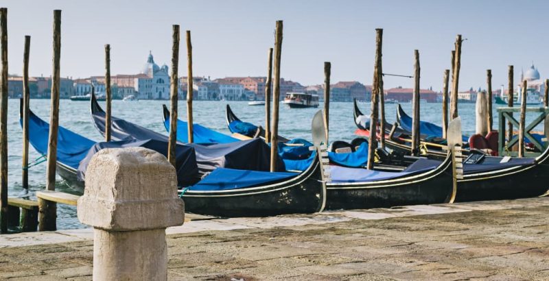 Old stone mooring bollard on quay of Venetian lagoon