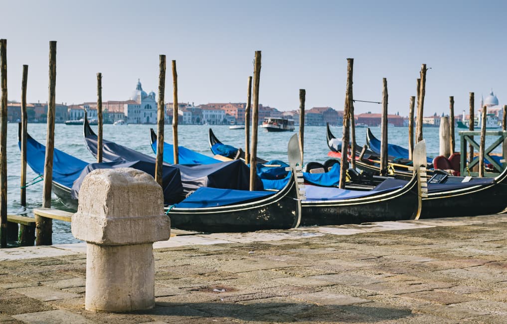 Old stone mooring bollard on quay of Venetian lagoon