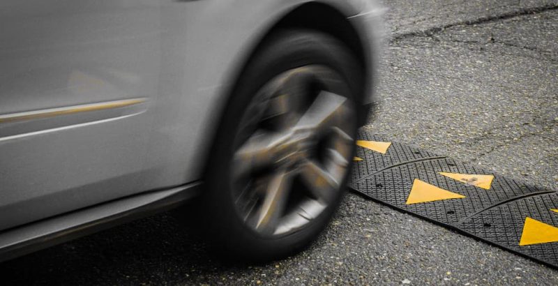 car driving over traffic calming speed ramp