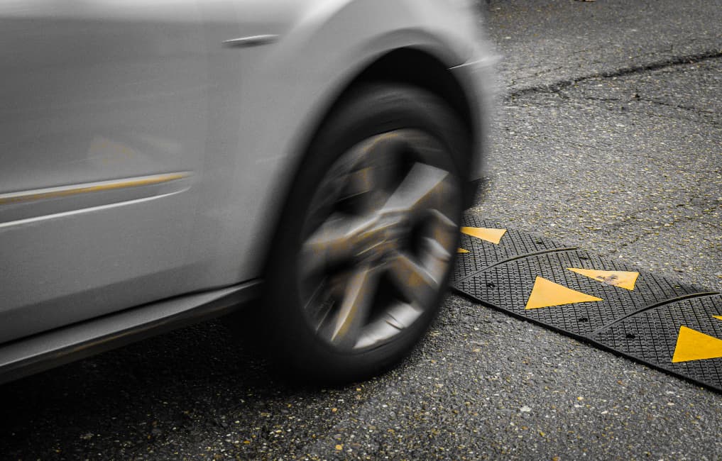 car driving over traffic calming speed ramp