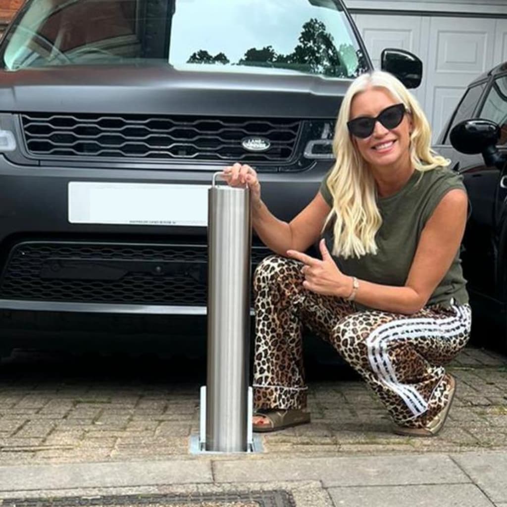 Denise Van Outen smiling at bollard