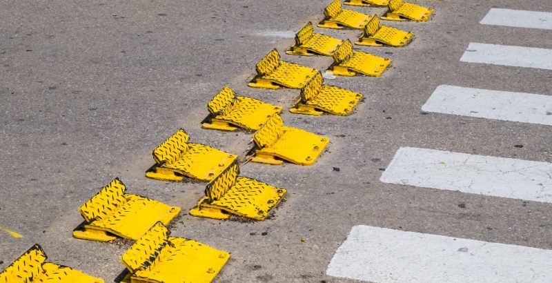 yellow traffic flow plates at crossing