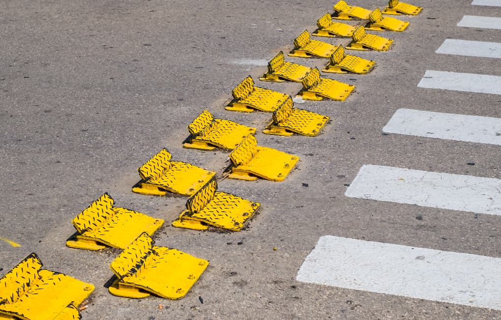 yellow traffic flow plates at crossing